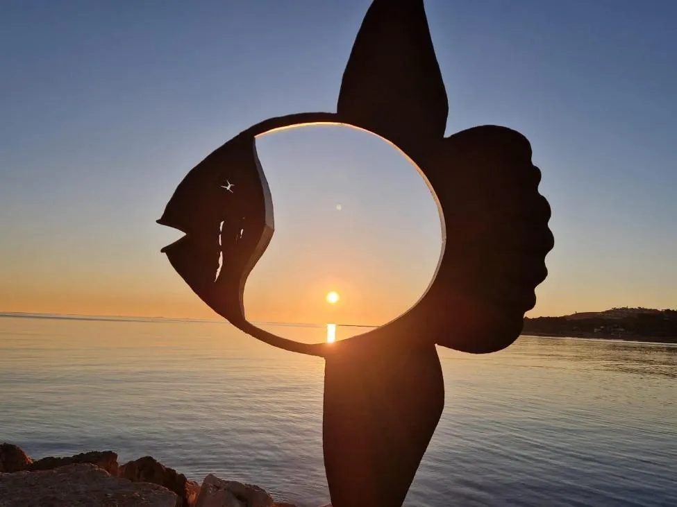 De Mola-sculptuur aan de kust van Dénia bij zonsondergang