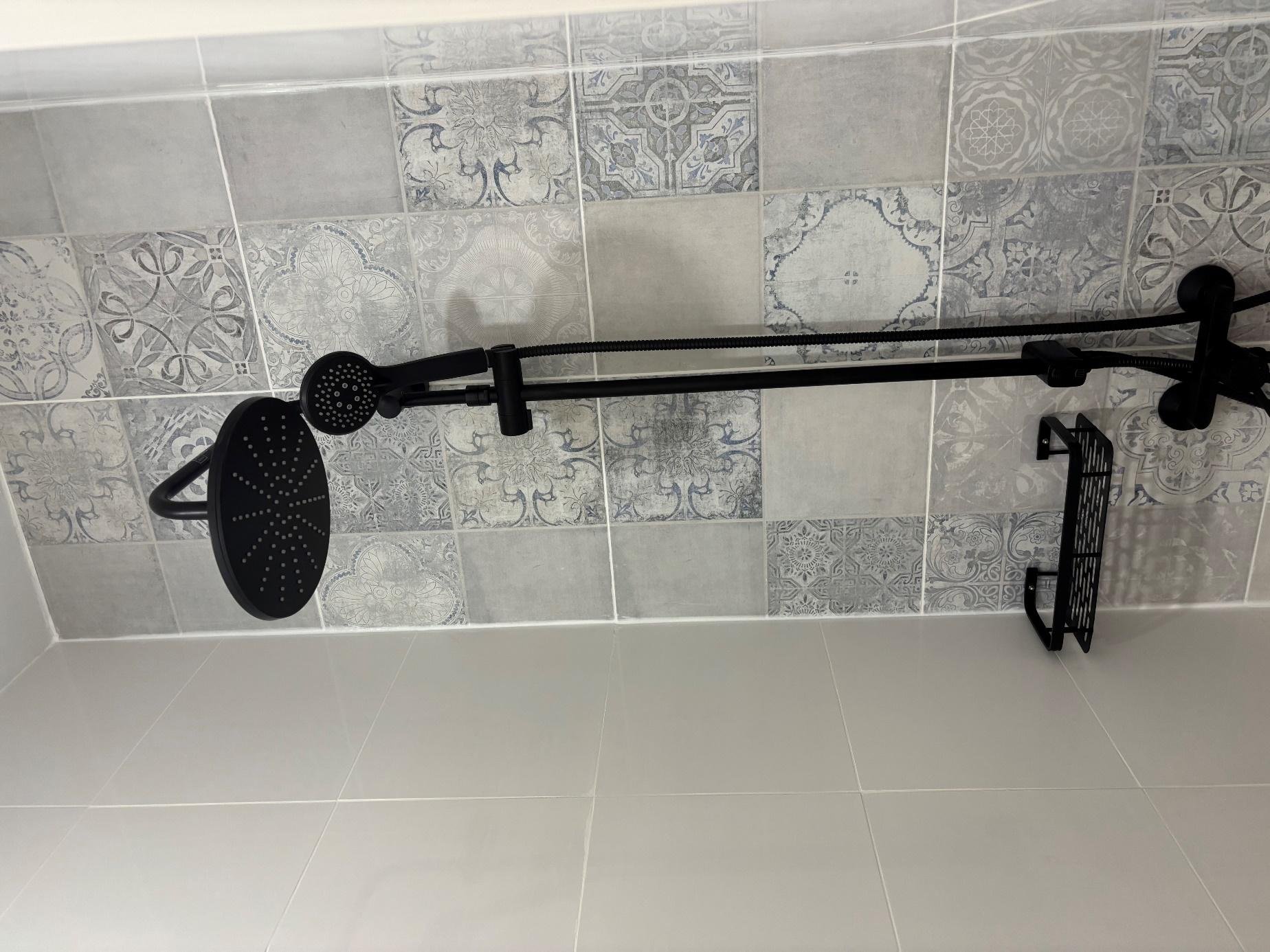 Badkamer met zwarte inloopdouche en cementtegels